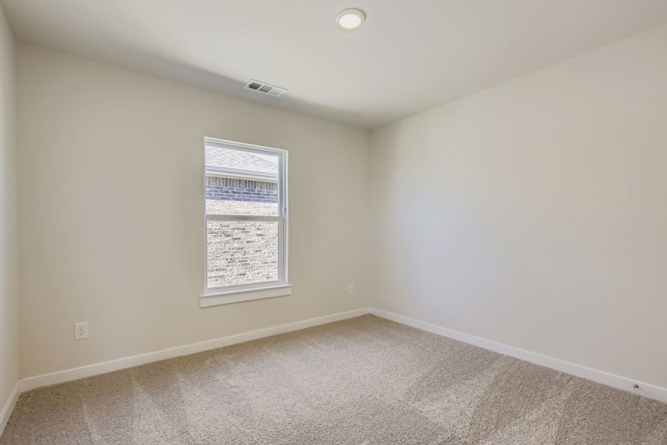 A room with a window and carpet.