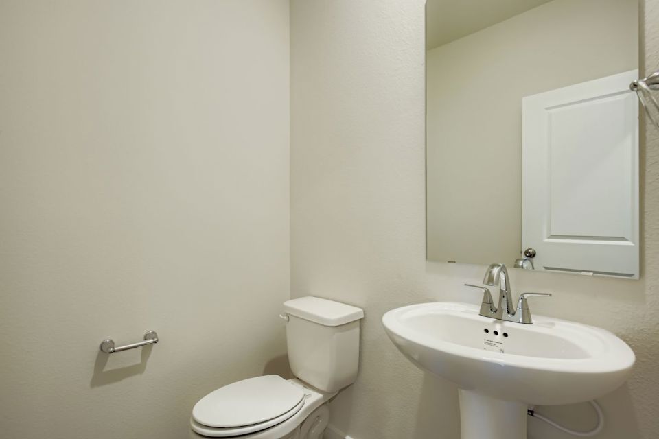A bathroom with a toilet and sink.
