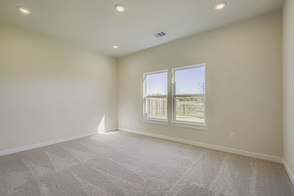 A room with a window and a carpet.