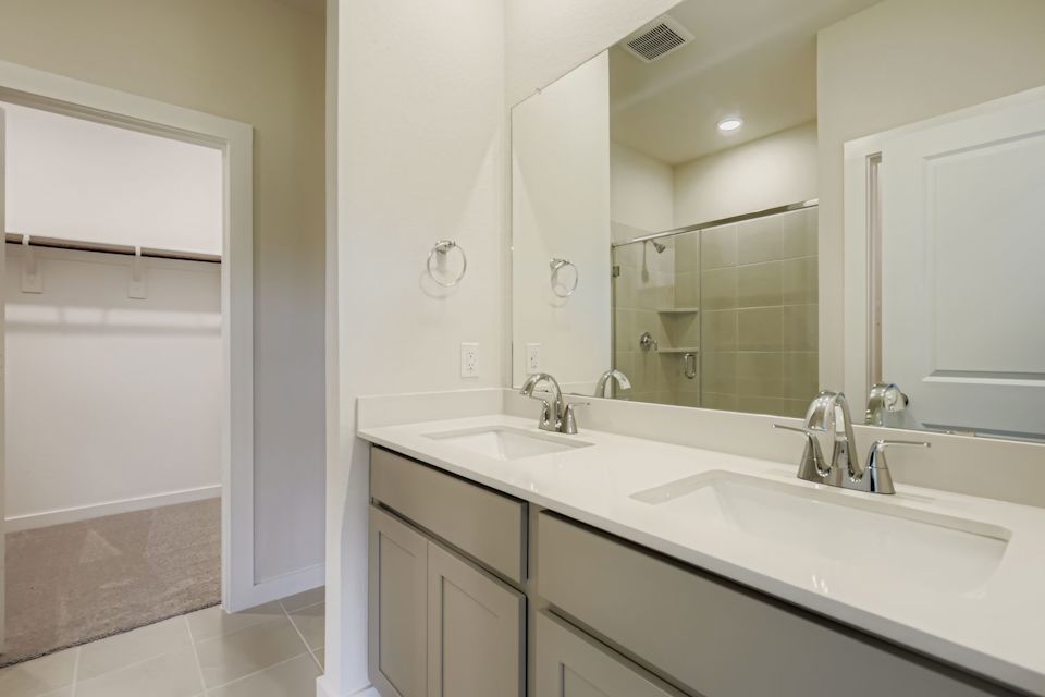 A bathroom with a large mirror.
