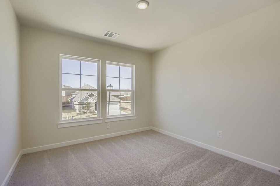 A room with a window and a carpet.