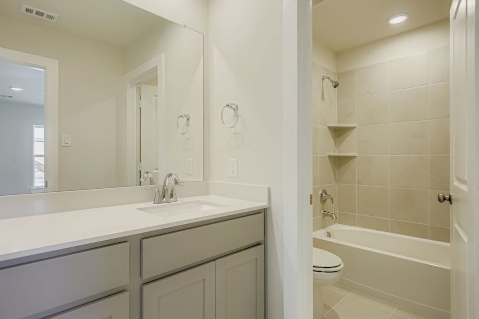 A bathroom with a tub sink and toilet.