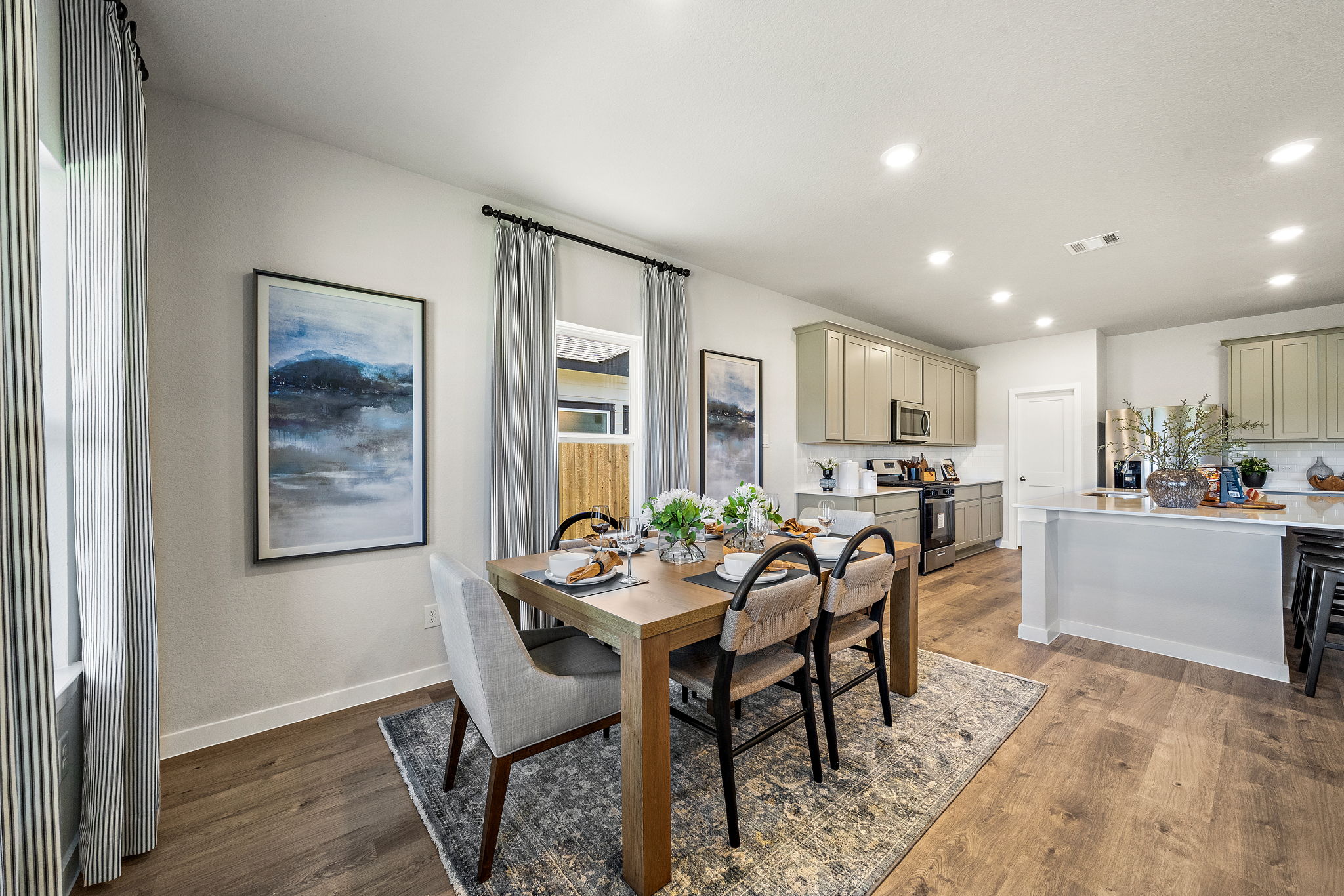 A dining room with a table and chairs.