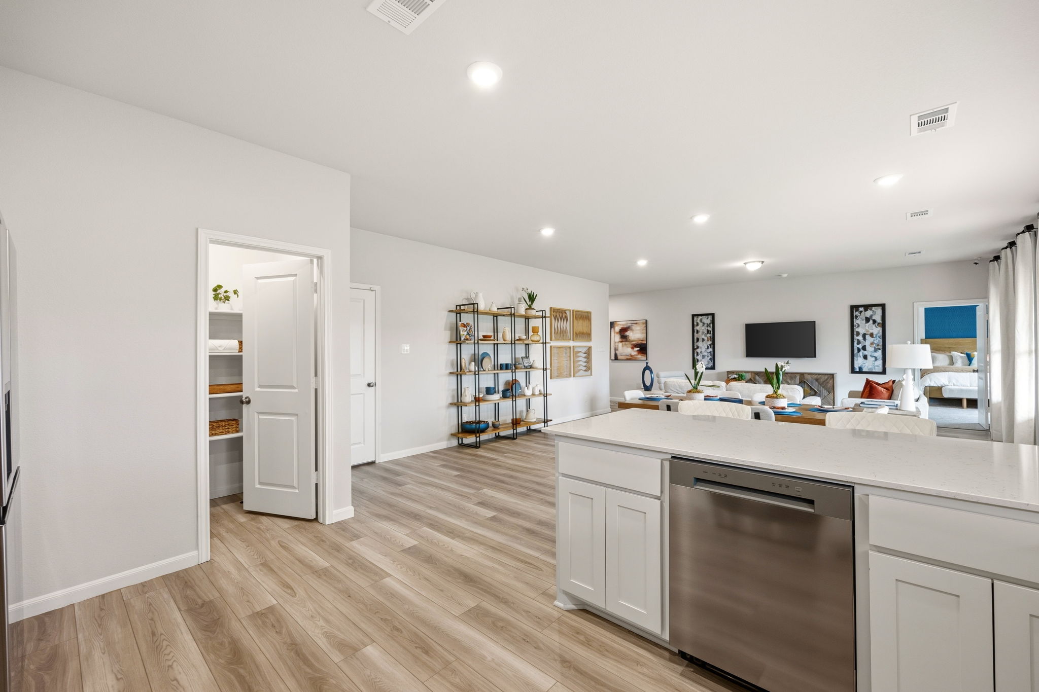 A kitchen with white cabinets.