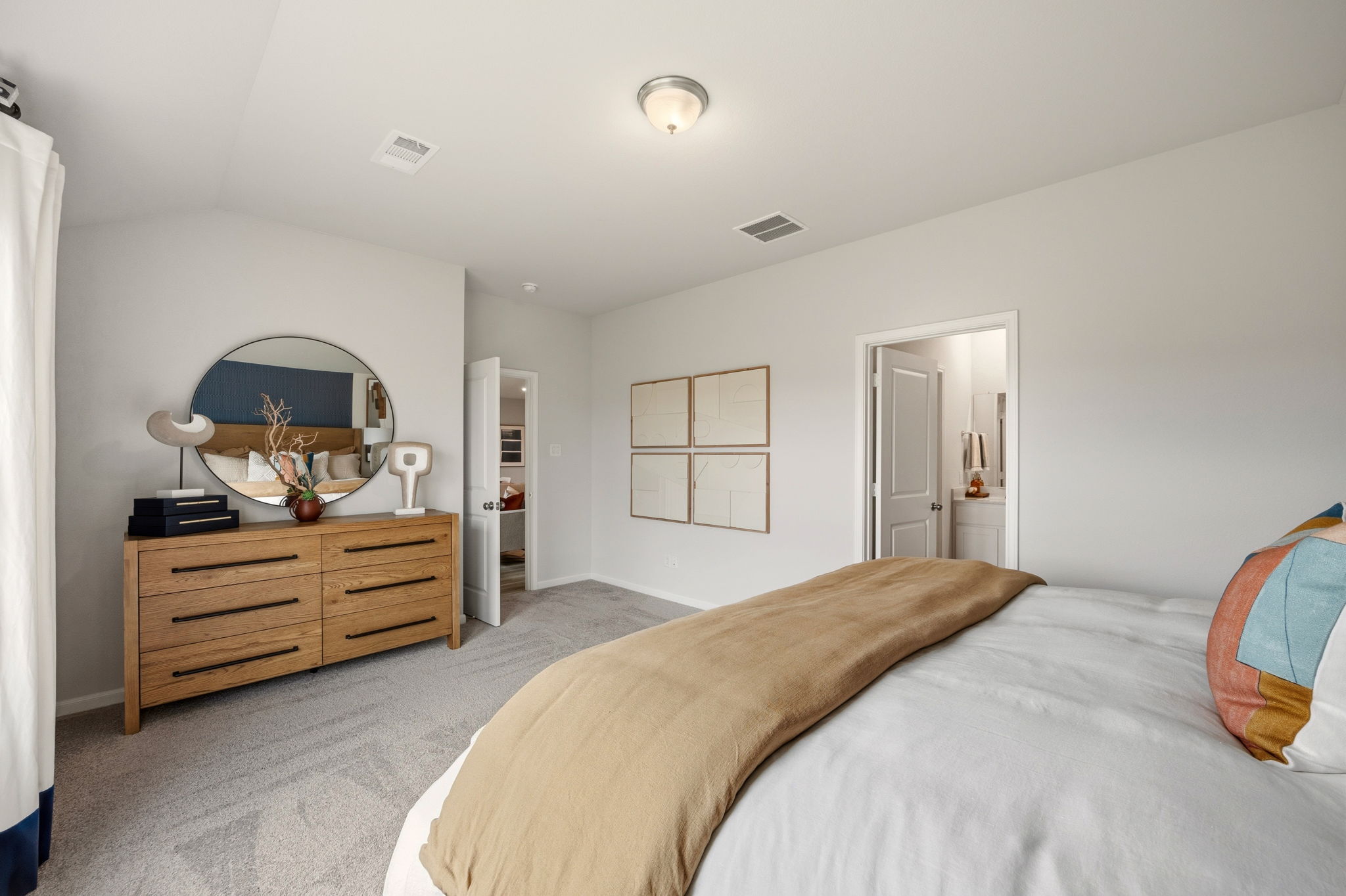 A bedroom with a bed and a dresser.