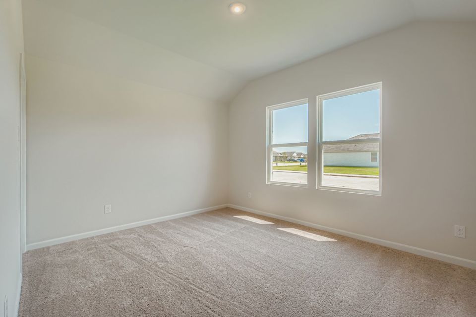 A room with a window and a carpet.