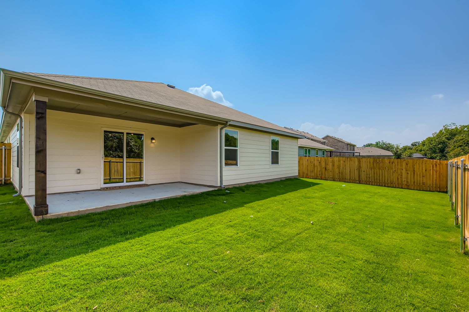 A house with a fence and grass.