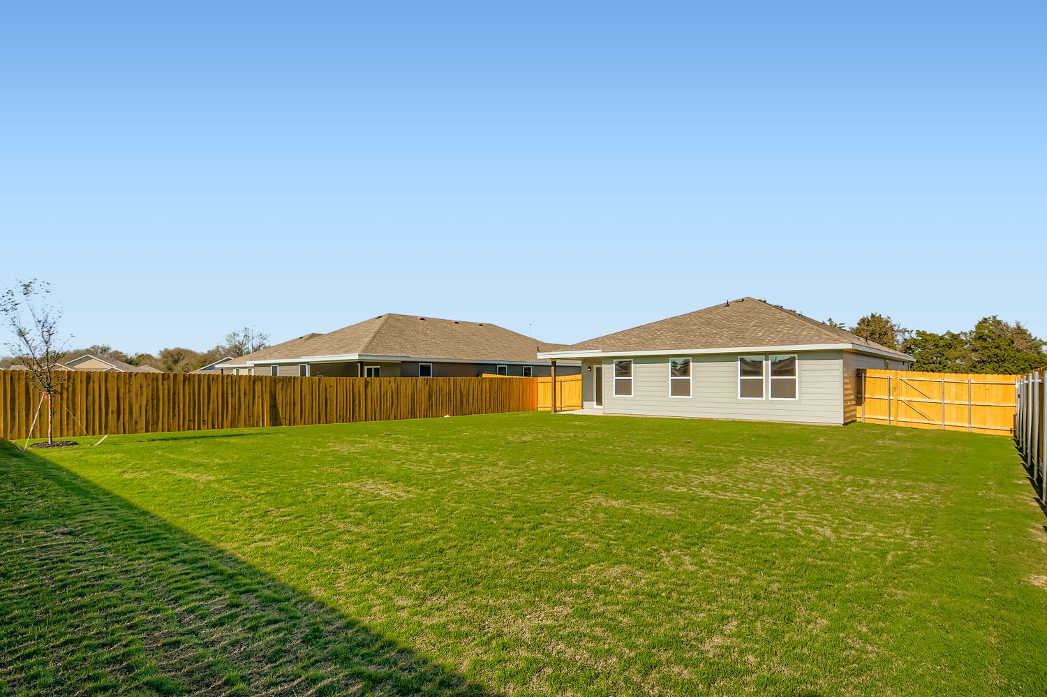 A house with a fence and grass.