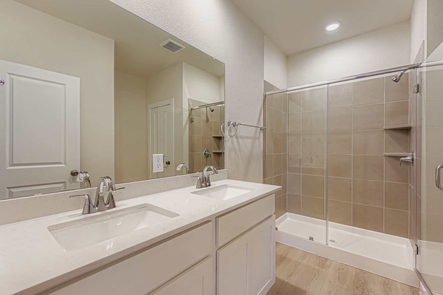 A bathroom with a large mirror.