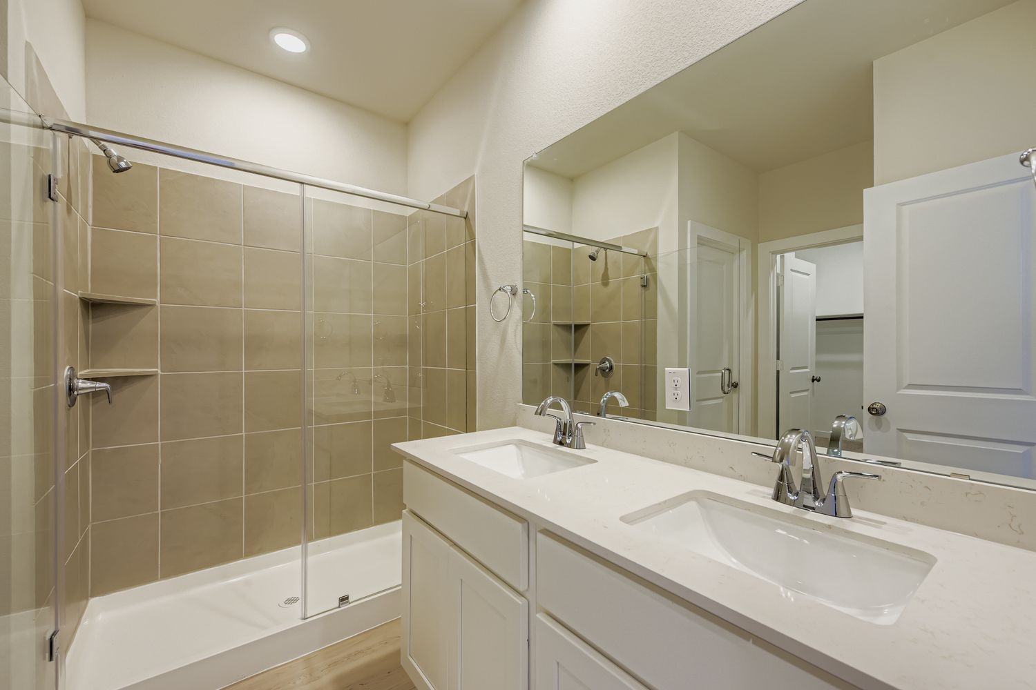 A bathroom with a large mirror.