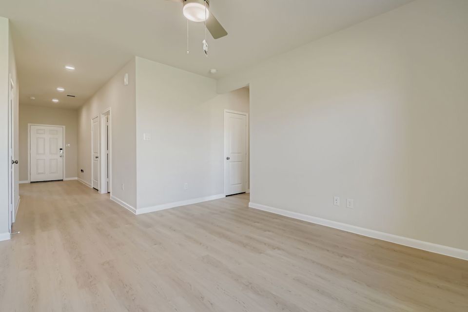 A room with white walls and a wood floor.