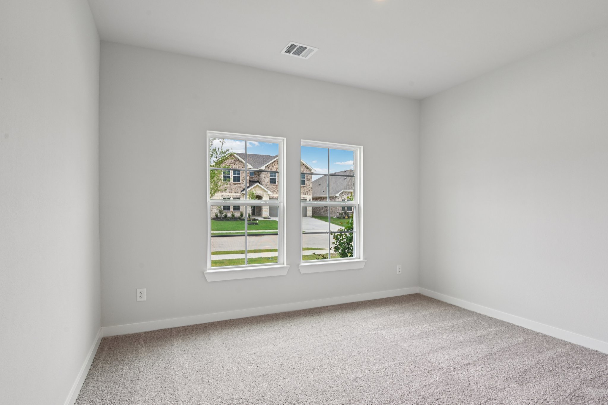 A room with a window and a carpet.