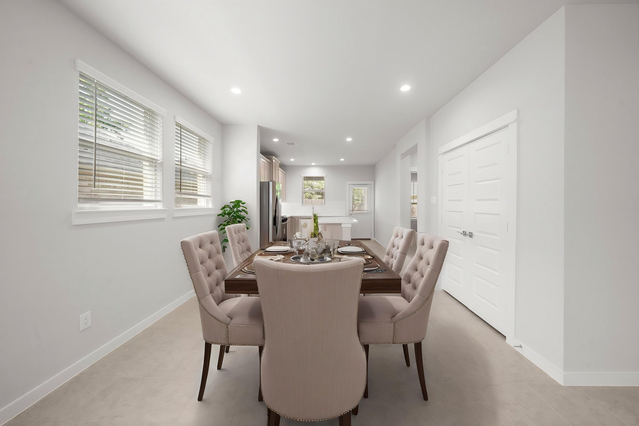 A dining room with a table and chairs.