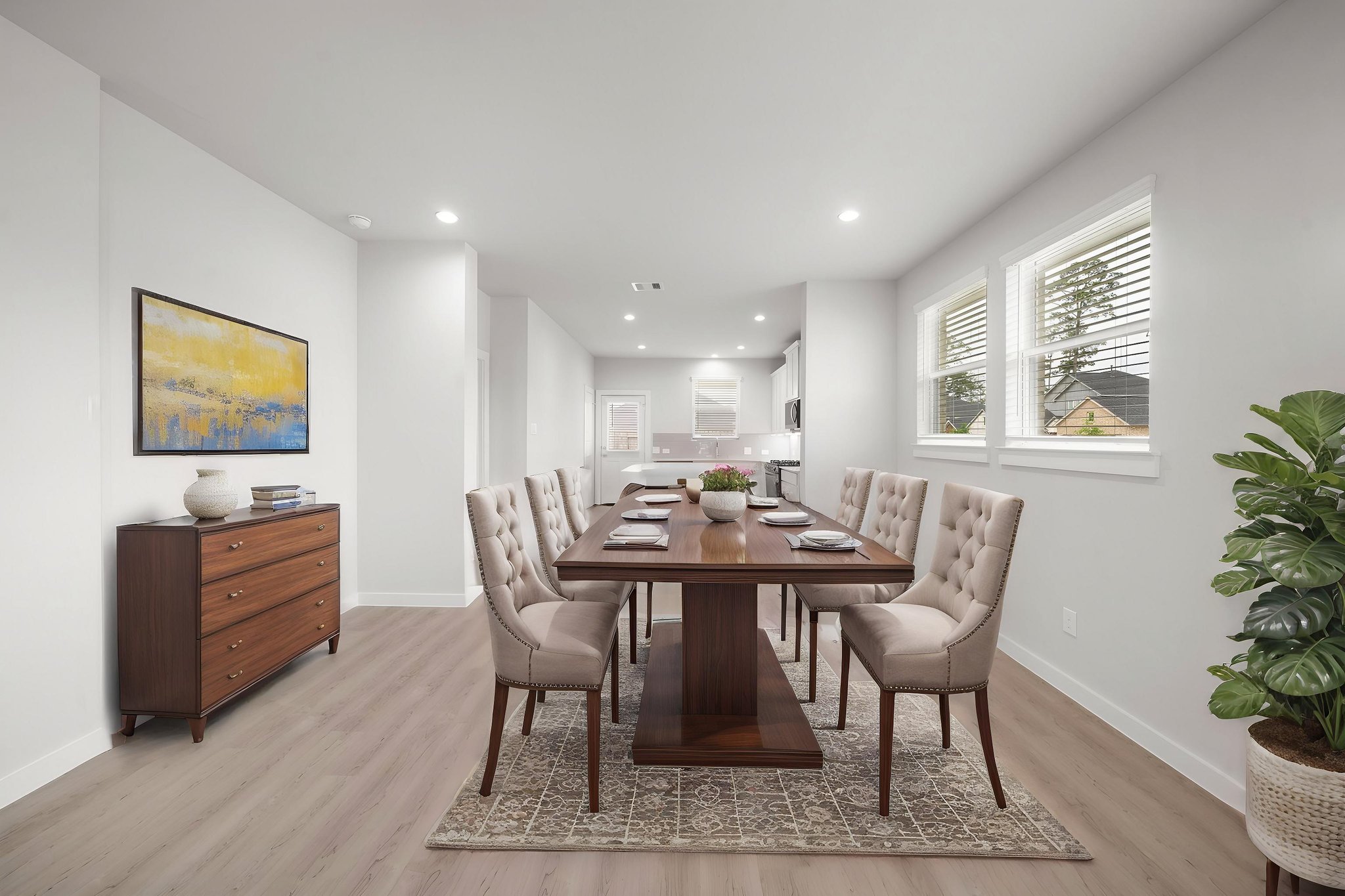 A dining room with a table and chairs.