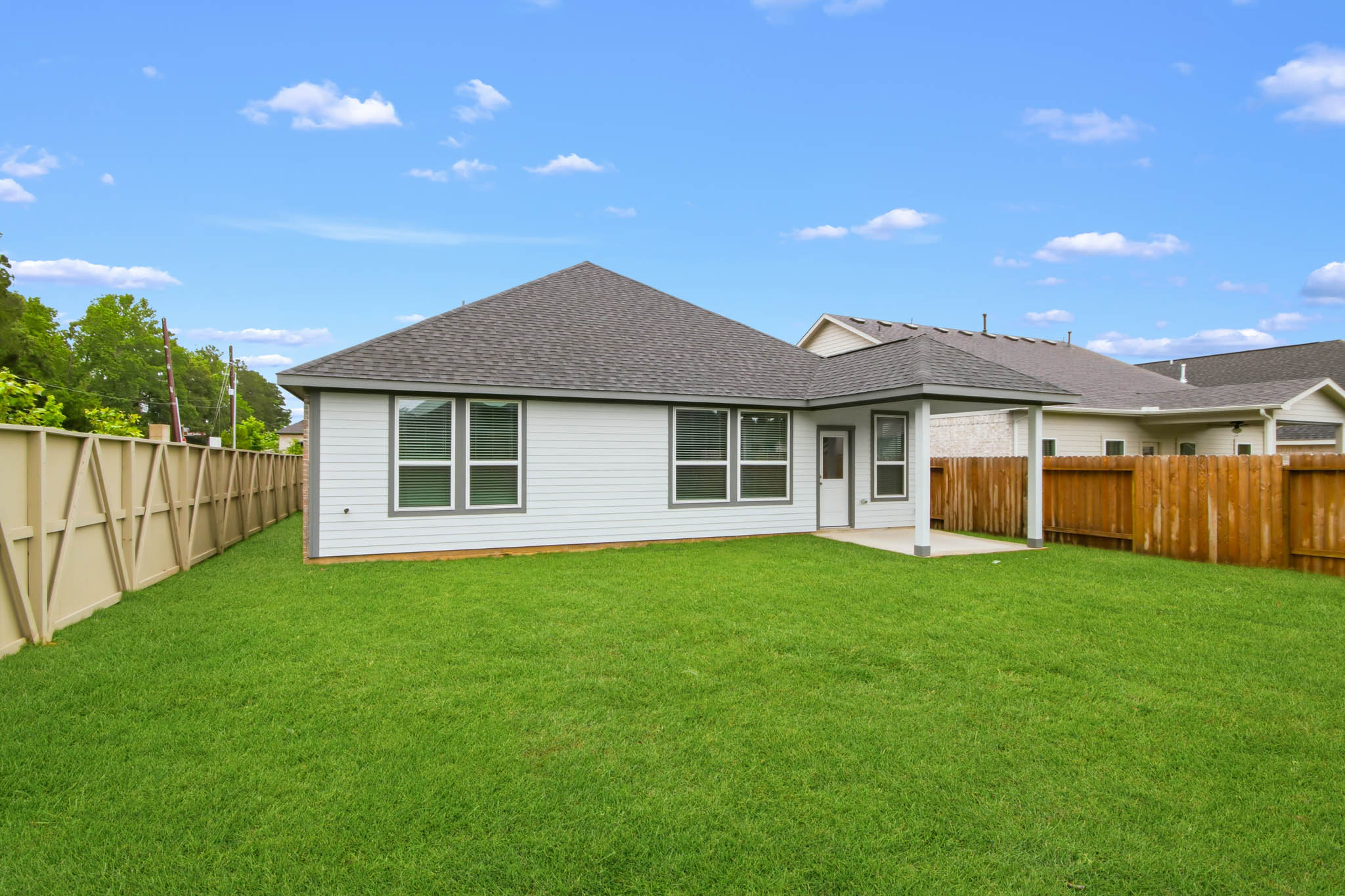 A house with a fence and grass.