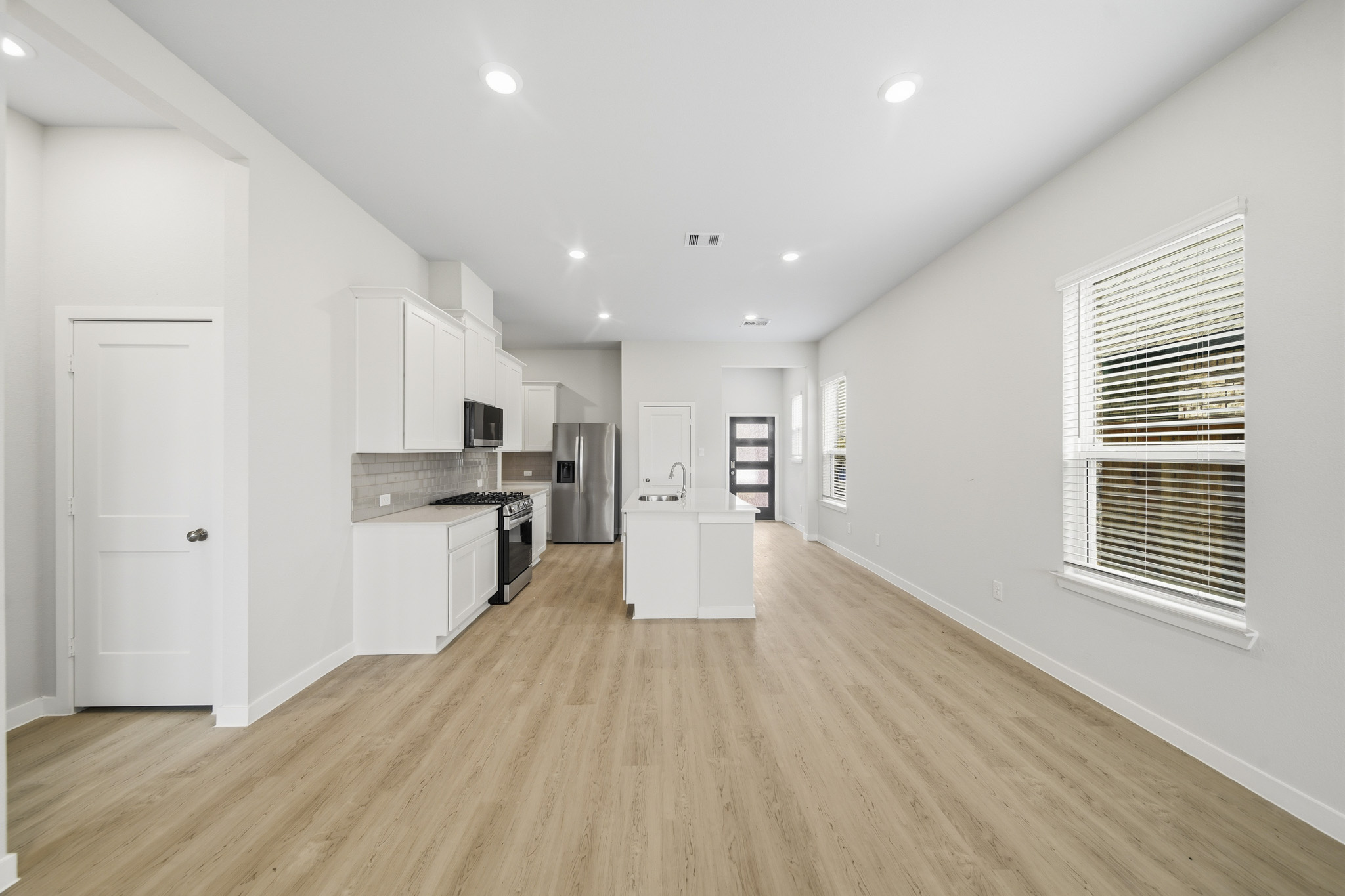 A kitchen with white cabinets.
