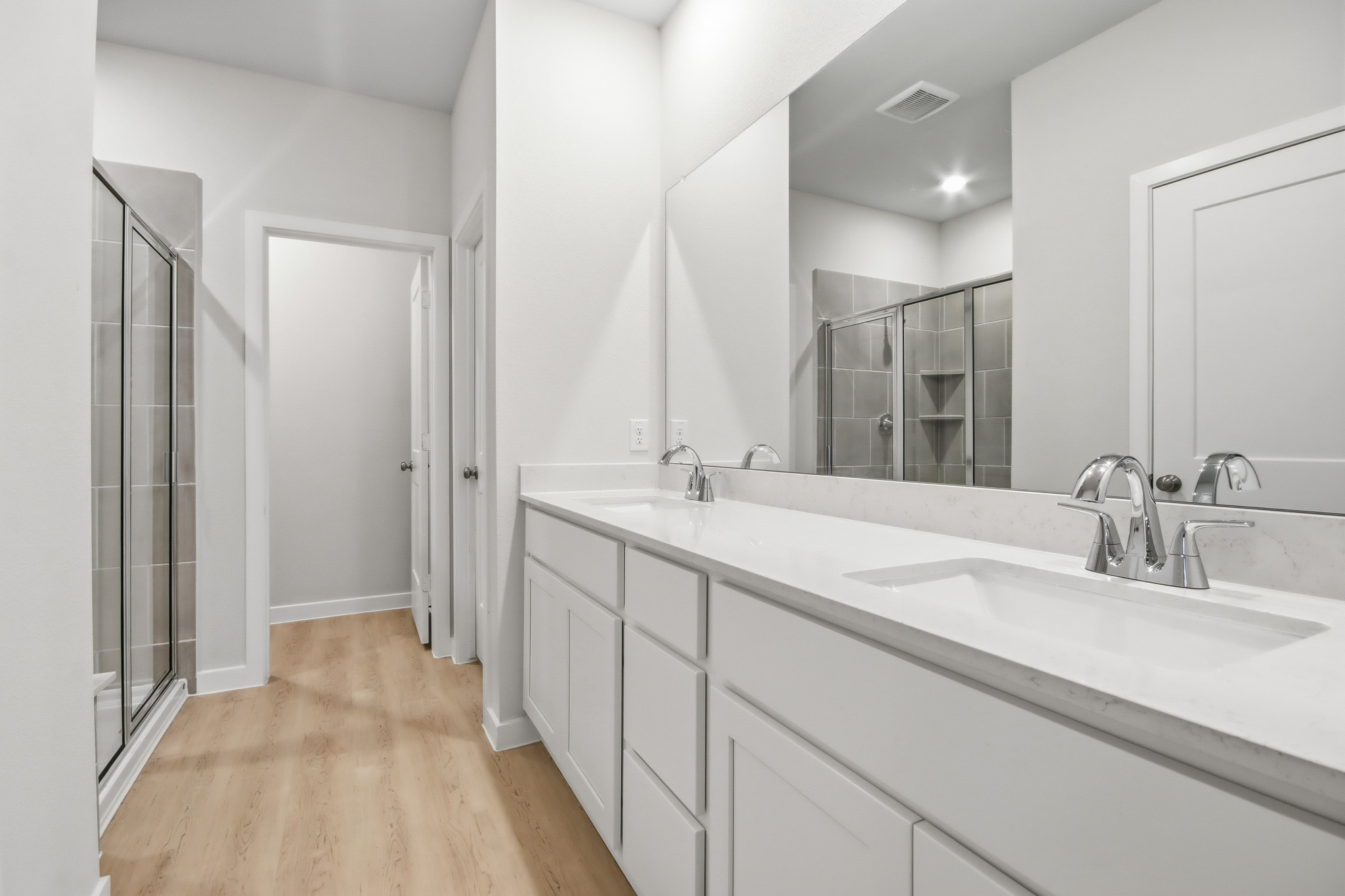 A bathroom with a large mirror.