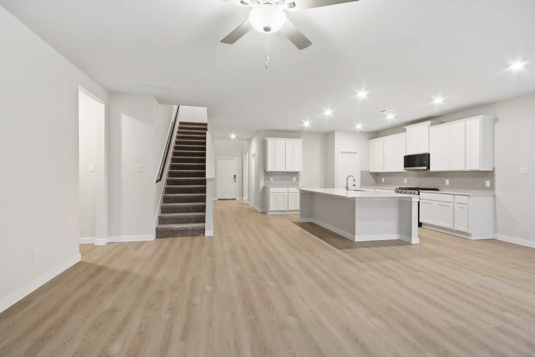 A large kitchen with white cabinets.