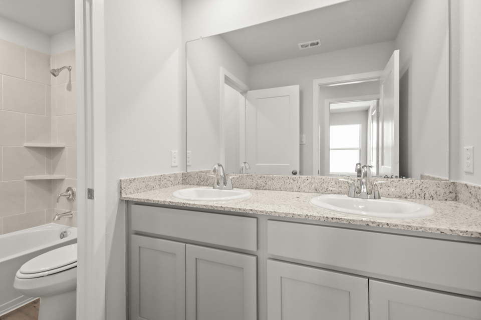 A bathroom with a marble countertop.