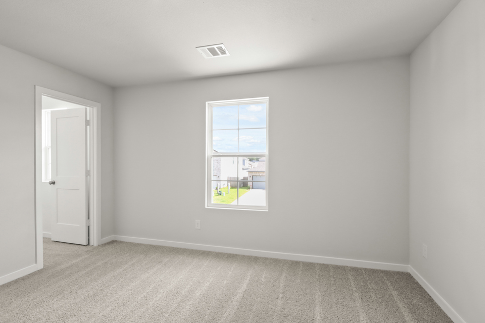 A room with a window and a door.