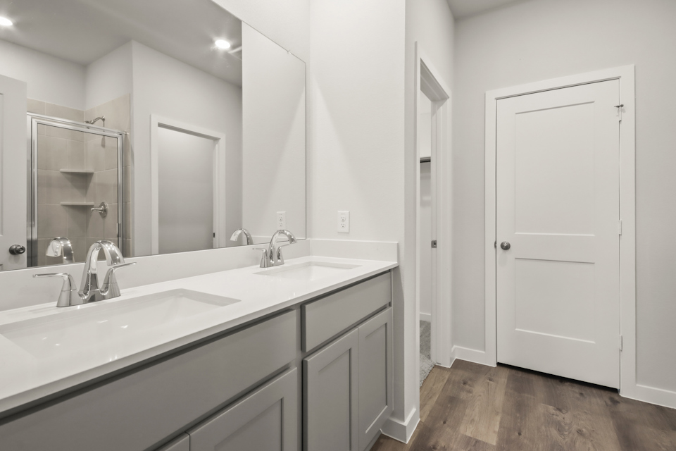 A bathroom with a large mirror.