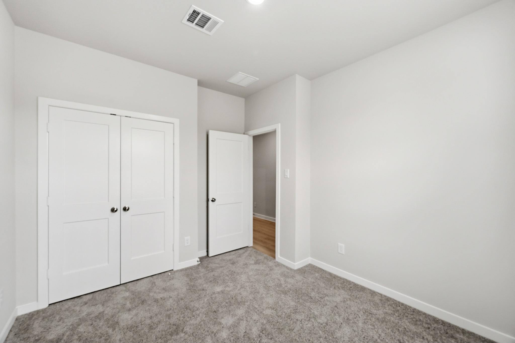 A hallway with white doors.