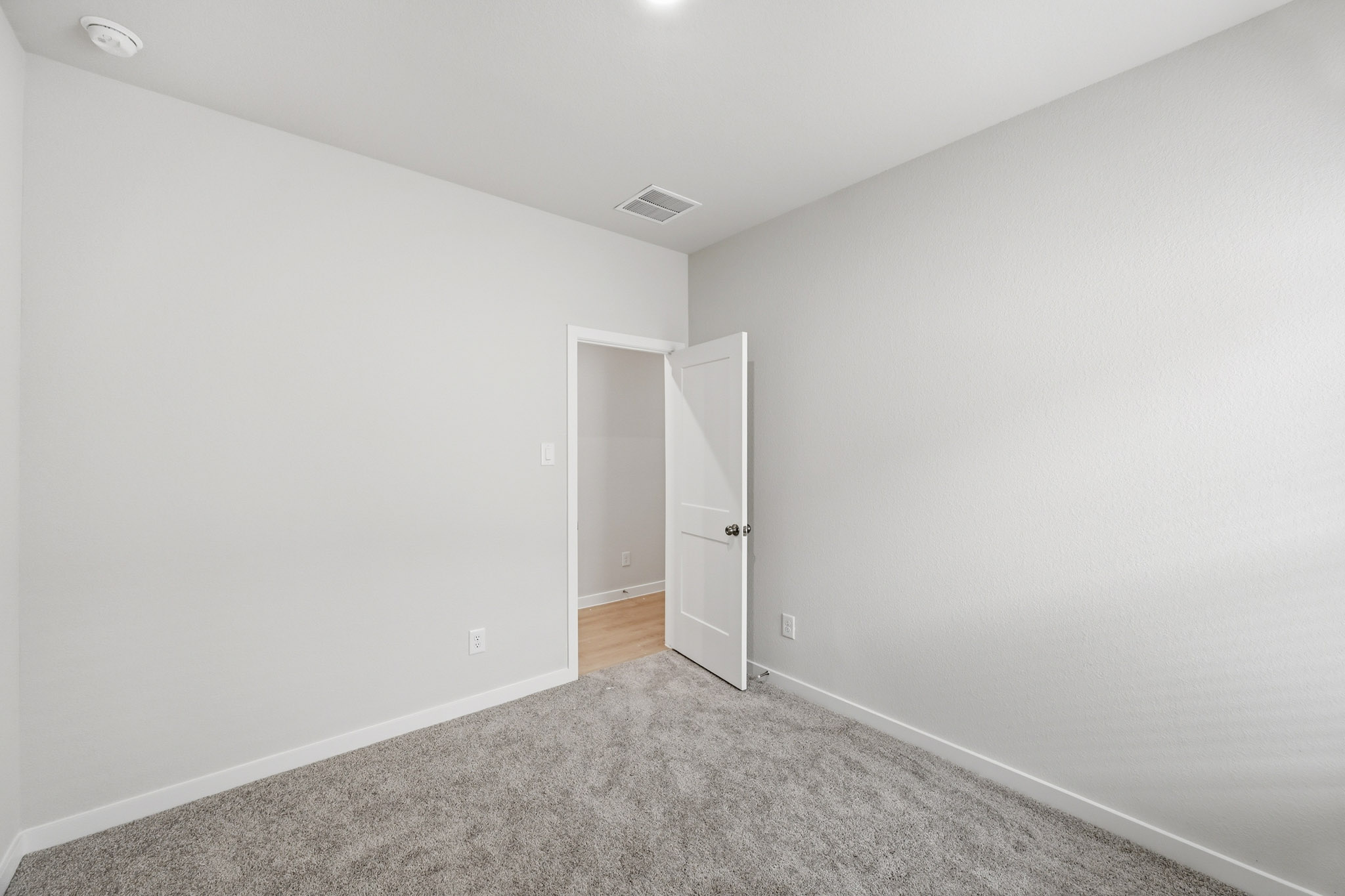 A hallway with white walls.