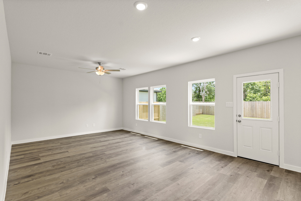 A room with a wood floor and a wood floor with a ceiling fan and a wood floor with.