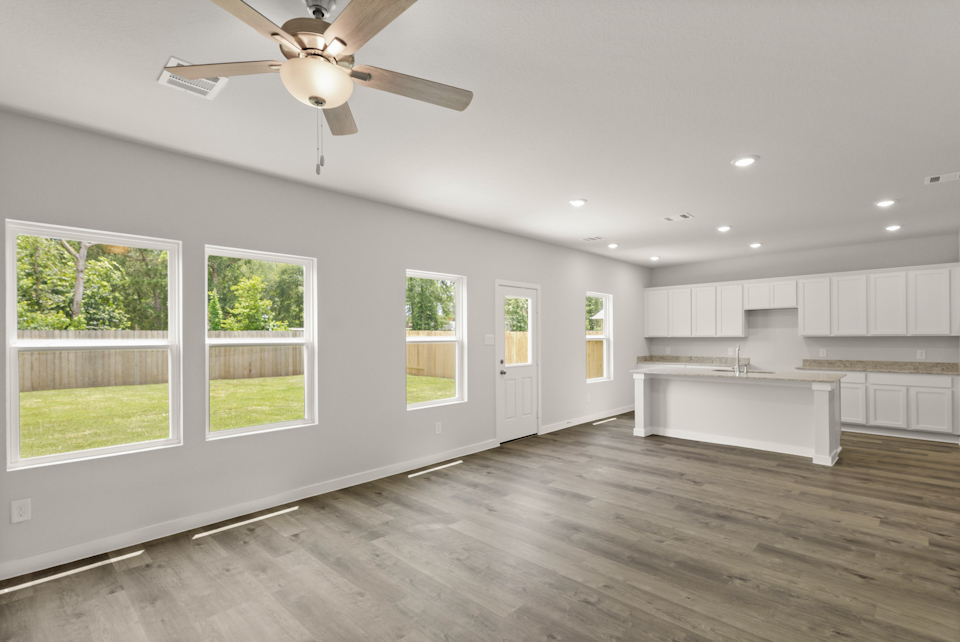 A room with a wood floor and a ceiling fan.