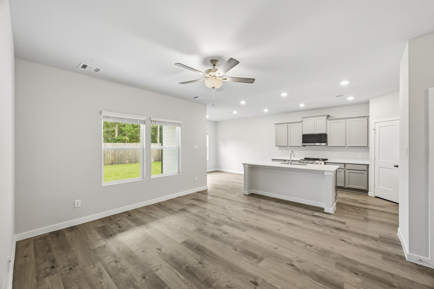 A kitchen with white cabinets.