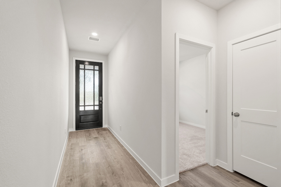 A hallway with white doors.