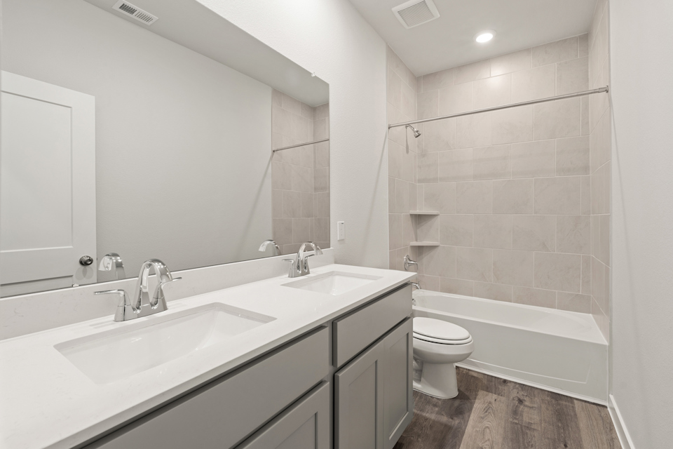 A bathroom with a tub sink and toilet.