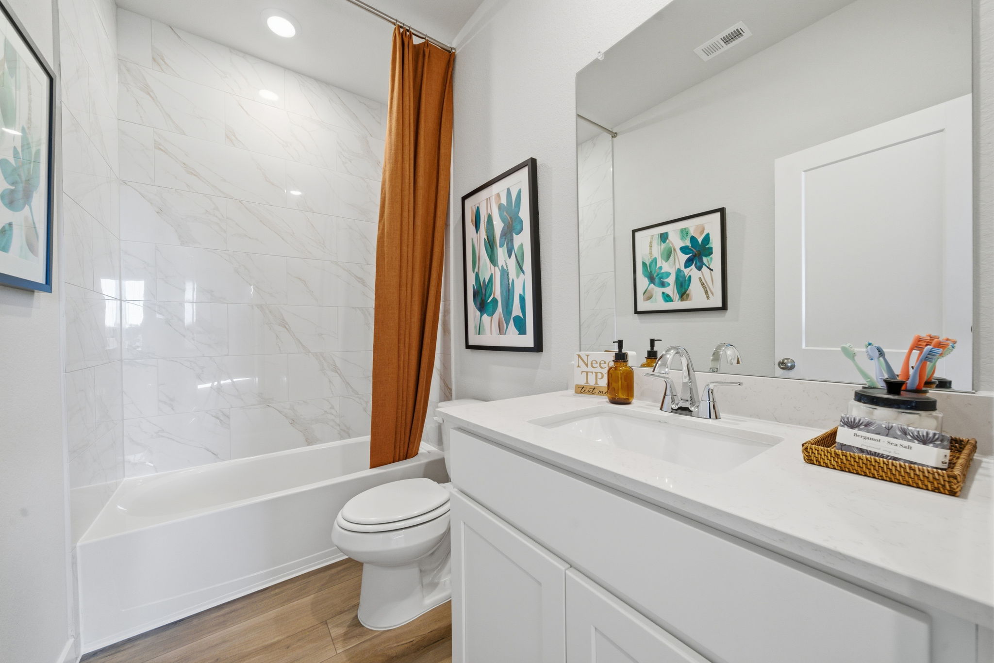 A bathroom with a tub sink and toilet.