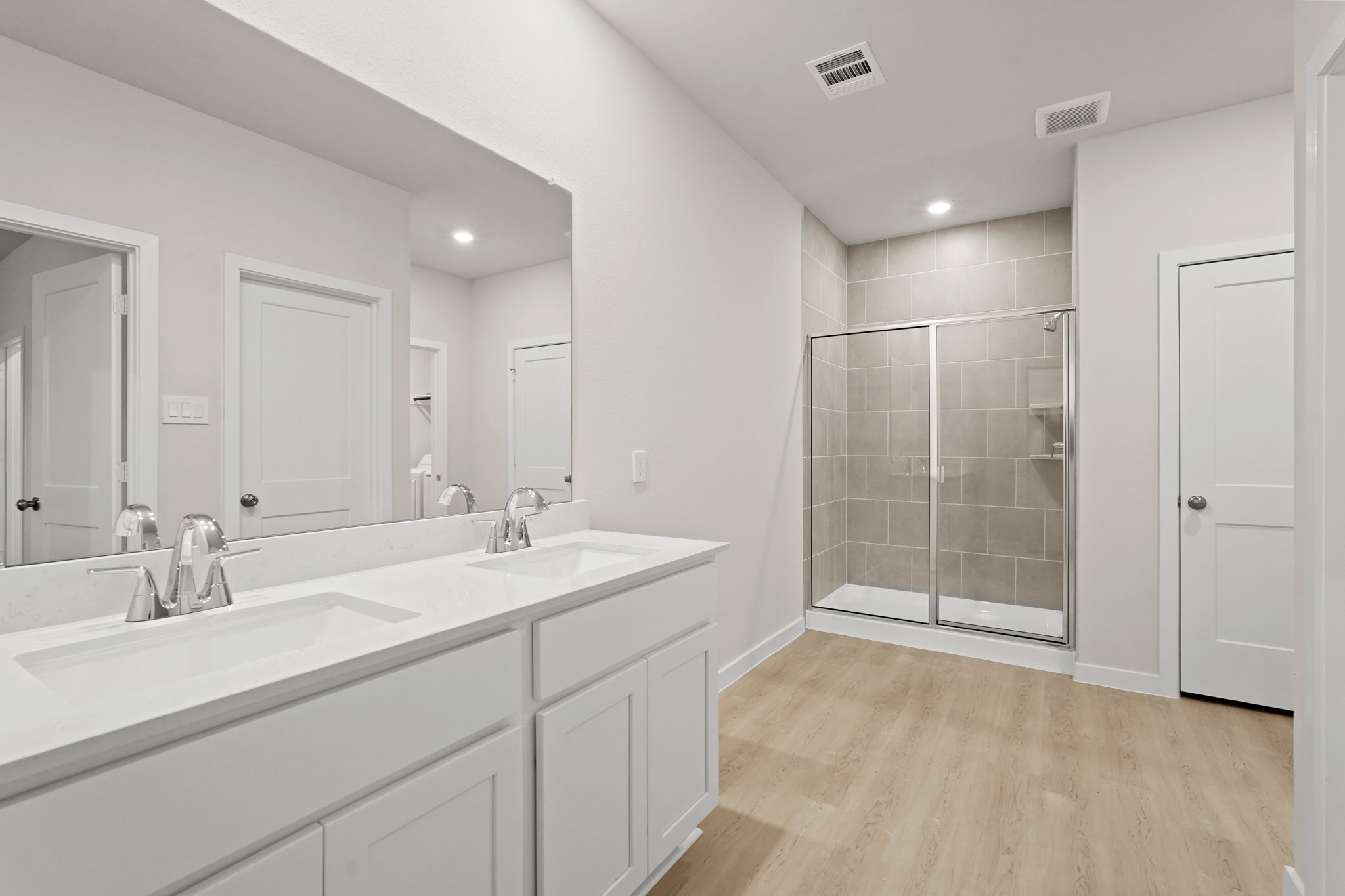 A bathroom with white cabinets.