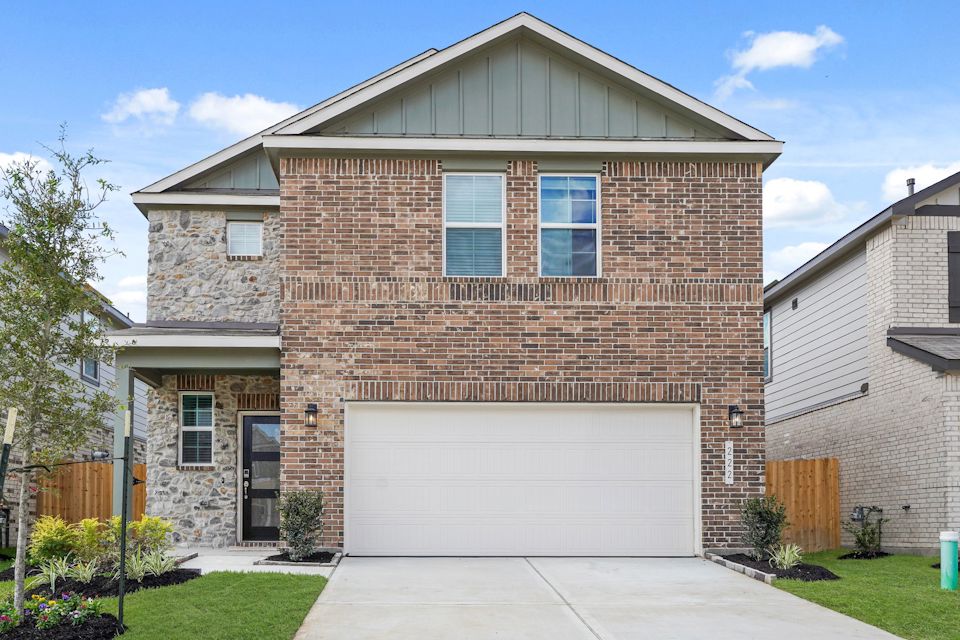 A brick house with a garage.