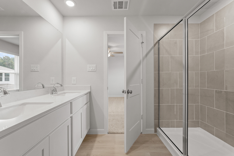 A bathroom with a shower and sink.