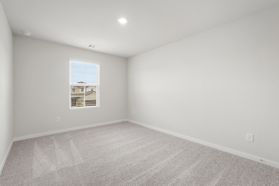 A room with a window and a vent.