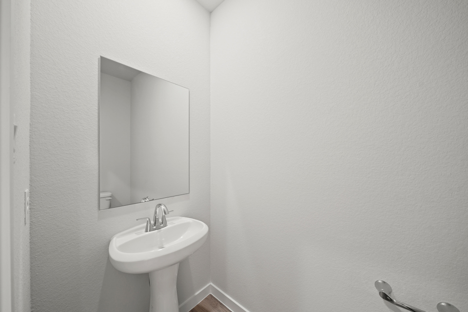 A bathroom with a mirror and sink.