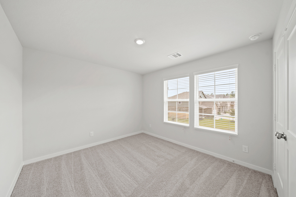 A room with a window and a carpet.