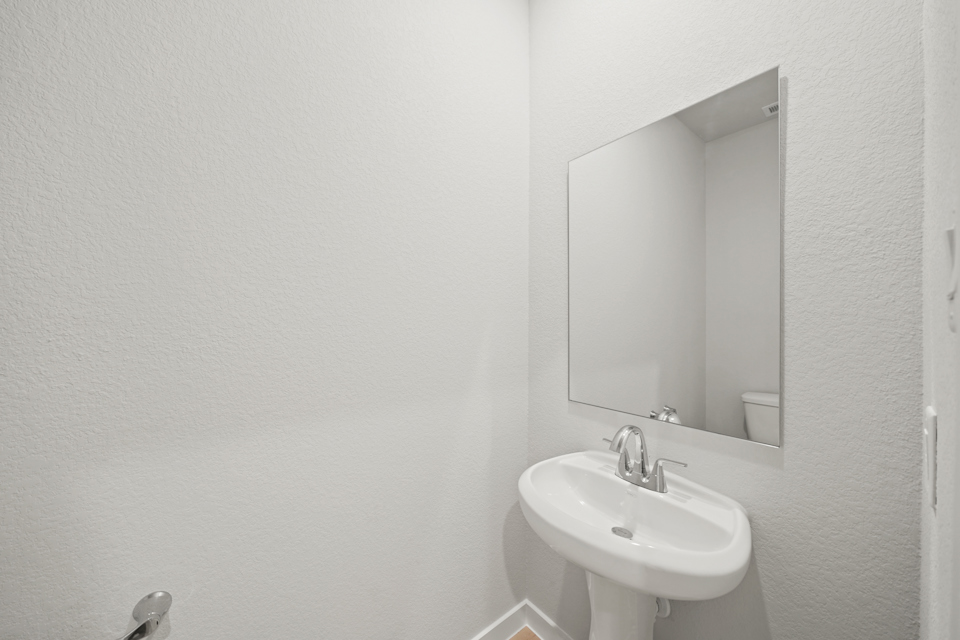 A bathroom with a mirror and sink.