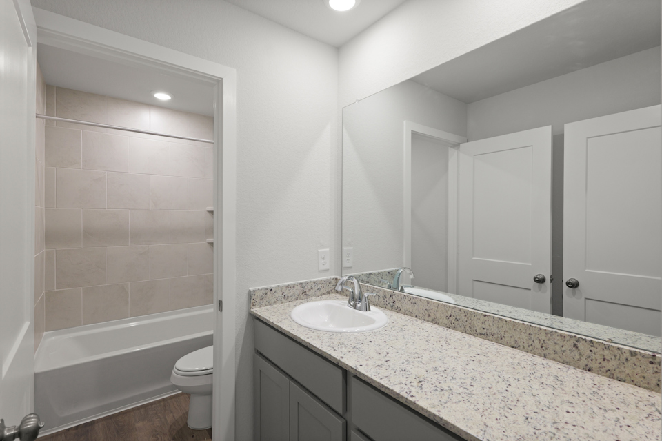A bathroom with a marble countertop.