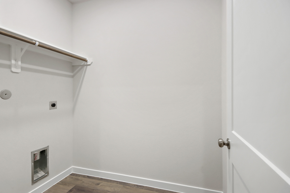 A white door with a metal bar.