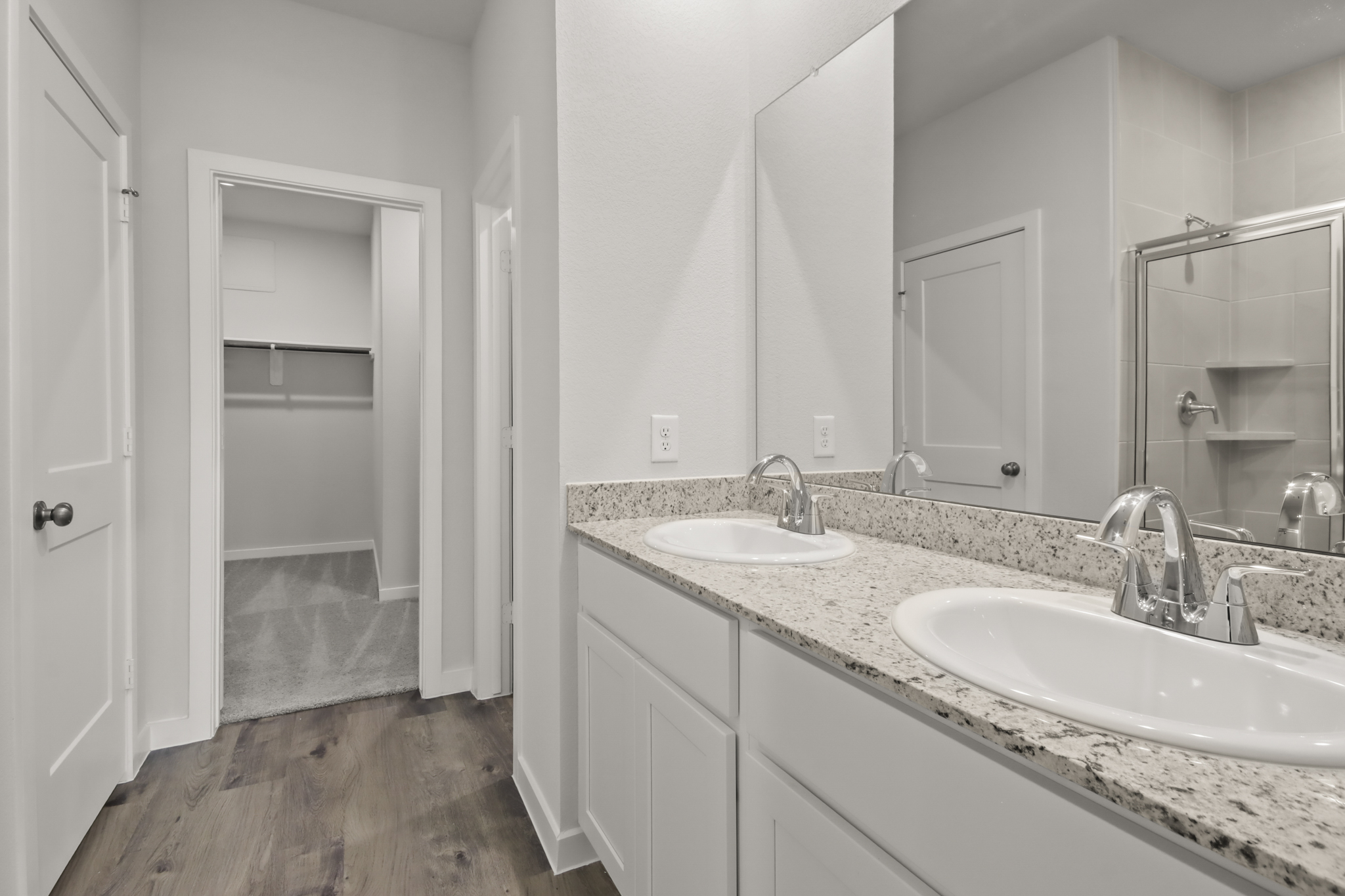 A bathroom with a large mirror.