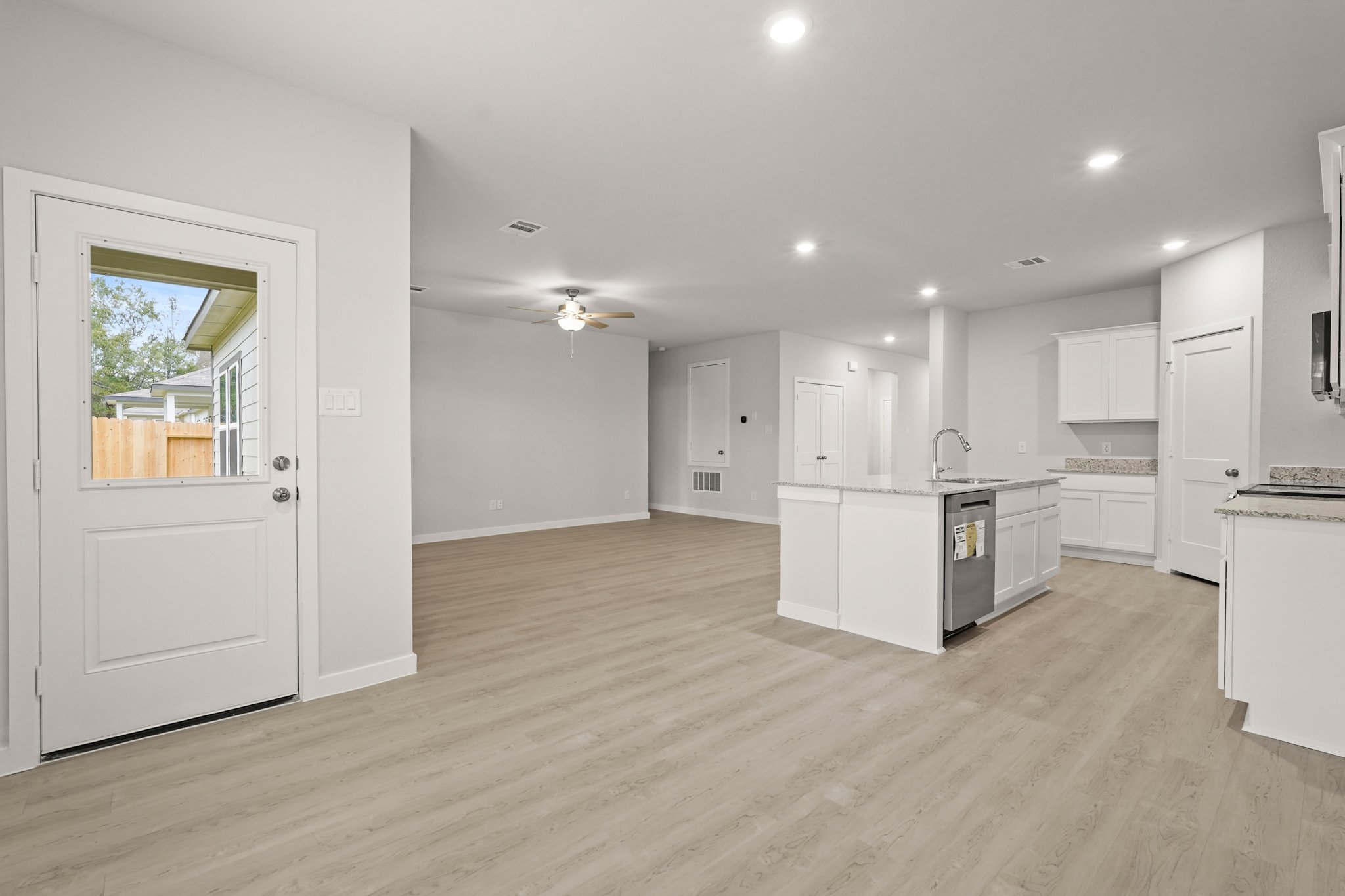 A kitchen with white cabinets.