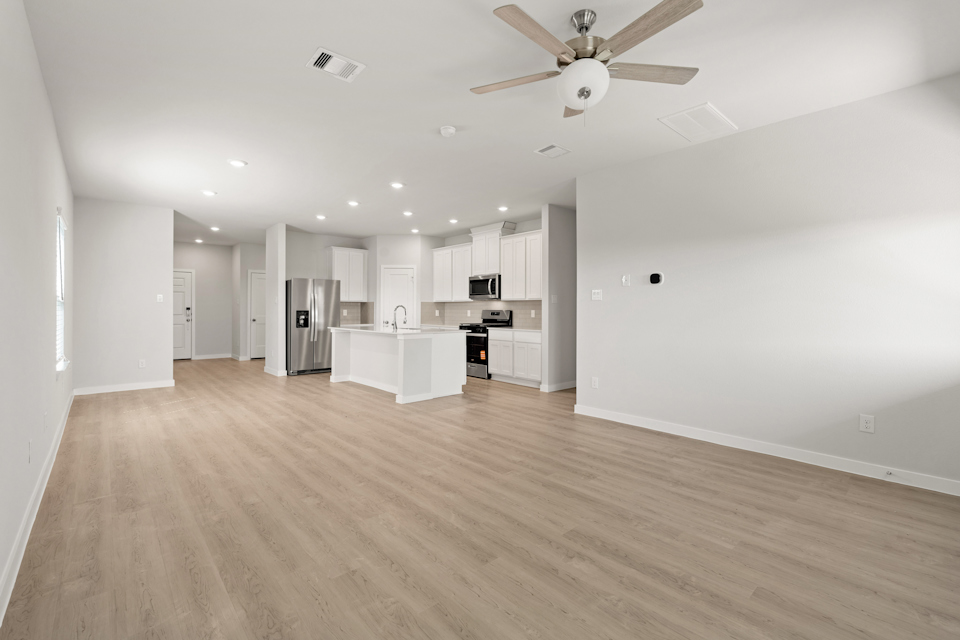 A large kitchen with white walls.