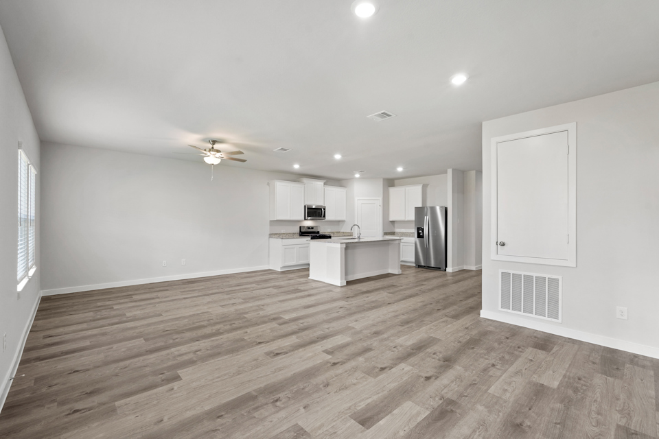 A kitchen with white cabinets.