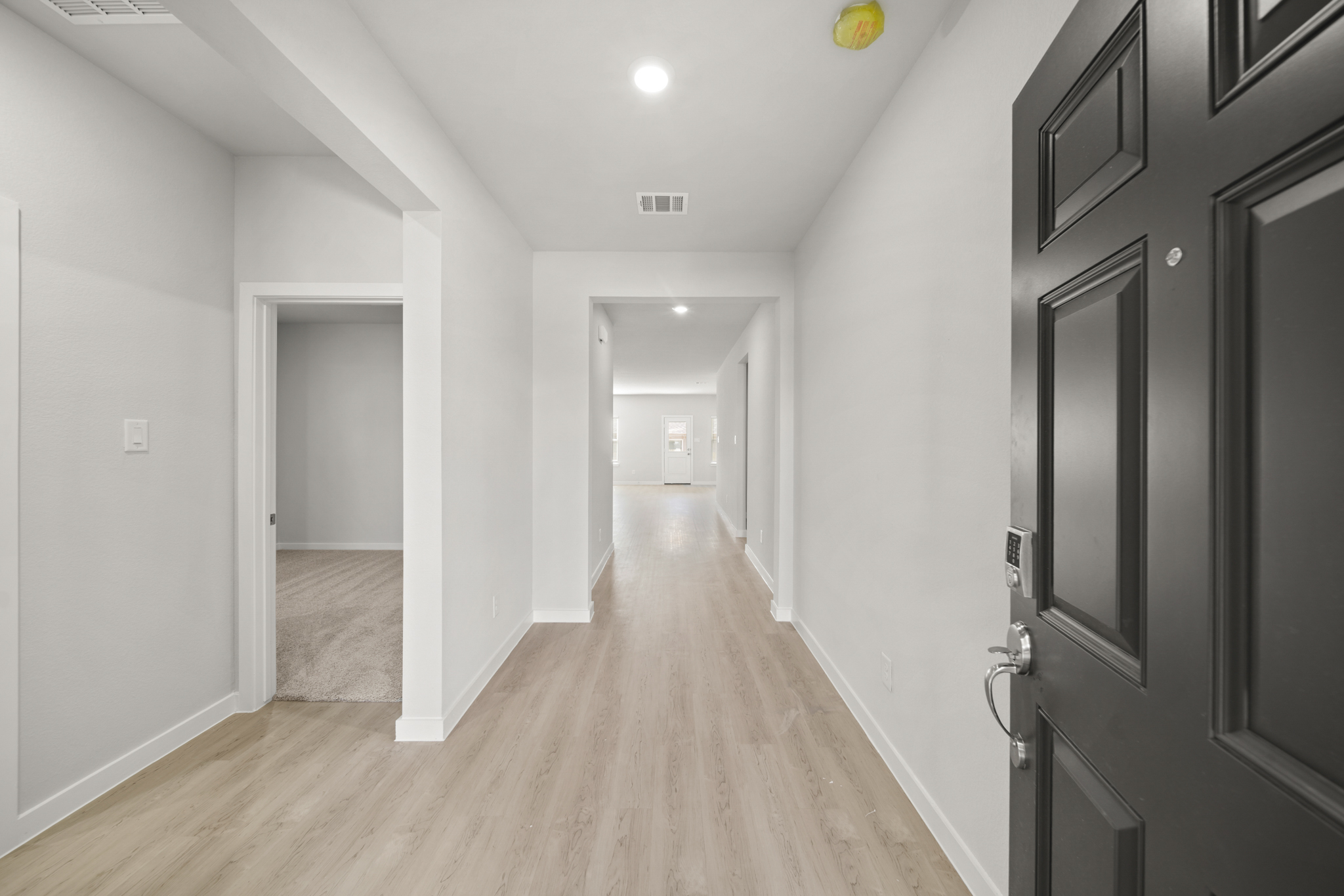 A hallway with white walls.