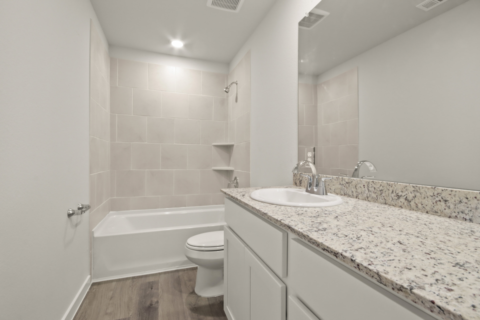 A bathroom with a marble countertop.