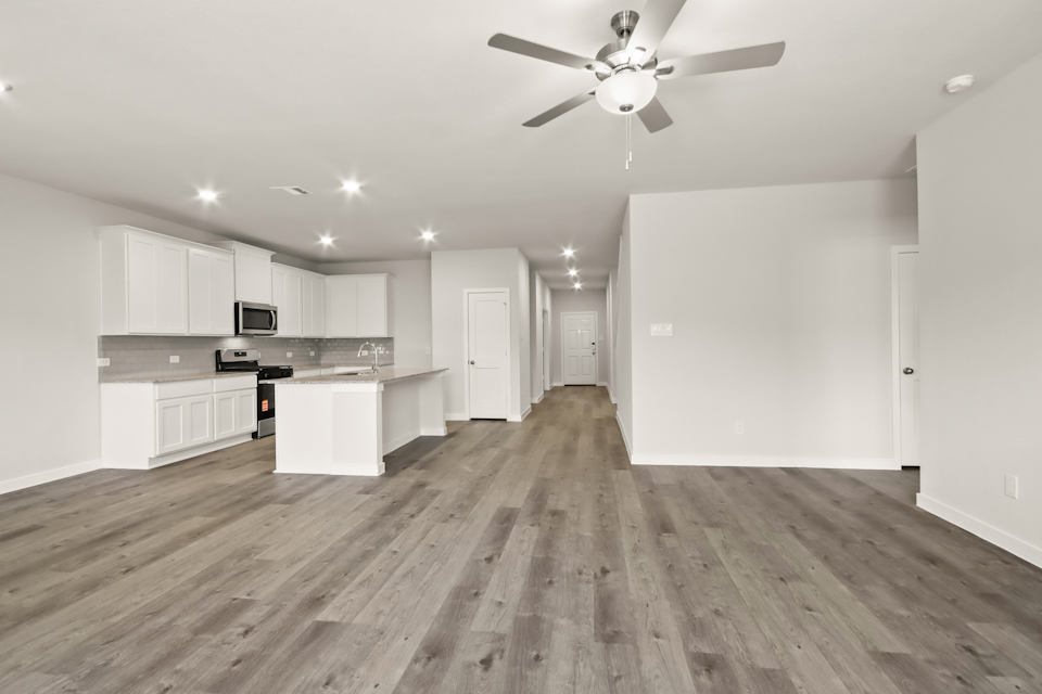 A large kitchen with white cabinets.
