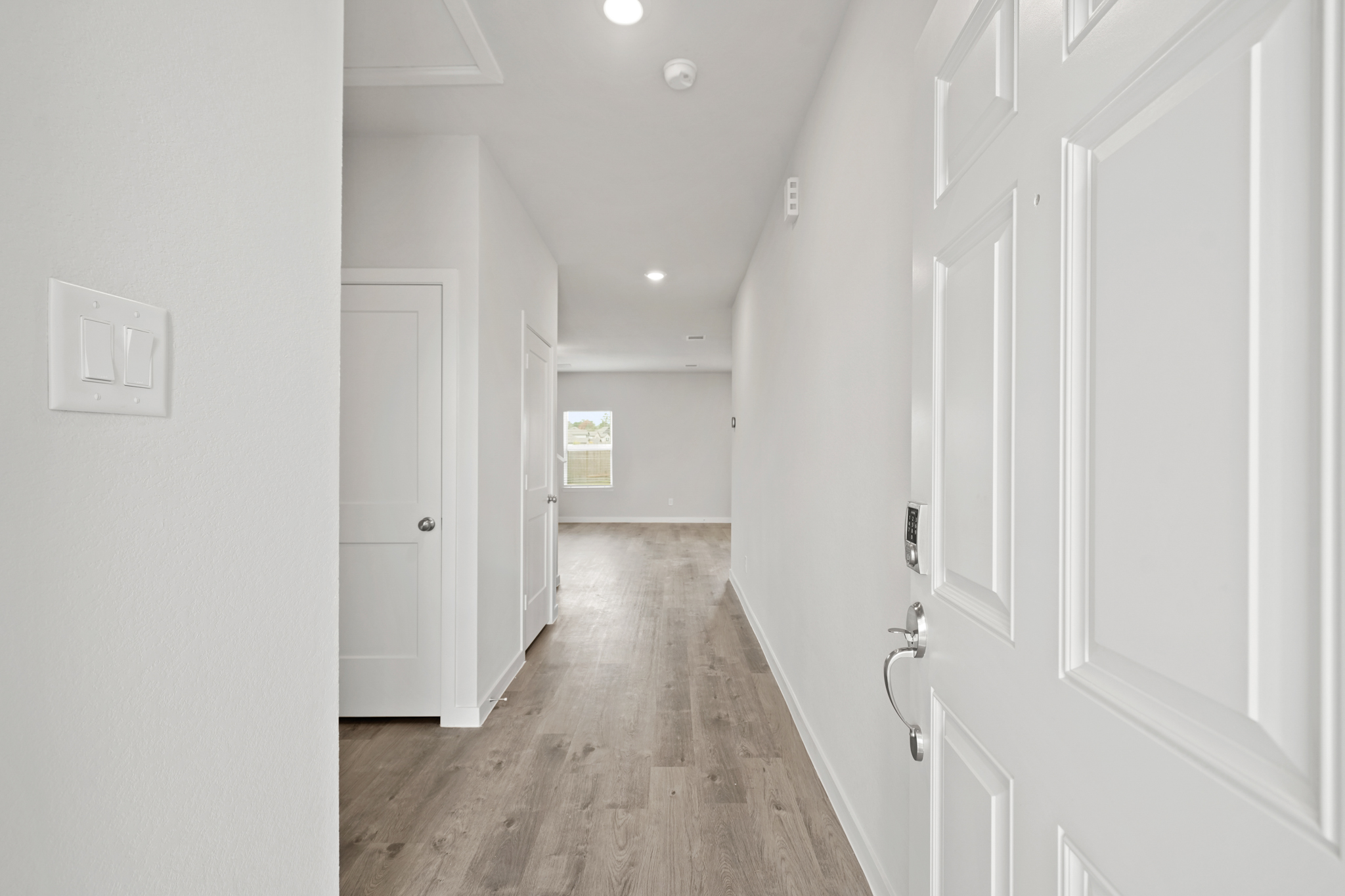 A hallway with white doors.